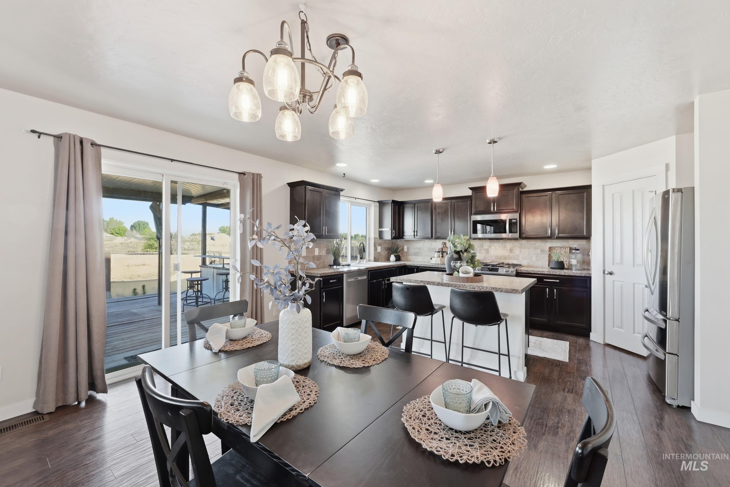 4855 South Chex Way Boise, ID 83709 - Photo 33 of 47 Open-concept kitchen and dining area with wood-finish flooring