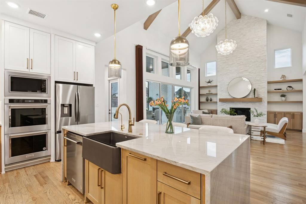 6281 Edgestone Drive Frisco, TX 75034 - Photo 11 of 40 Kitchen is connected to the living room & has a beautiful waterfall edge island. Perfect for entertaining or casual dining.