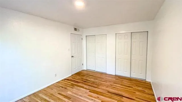 a view of a room with wooden floor