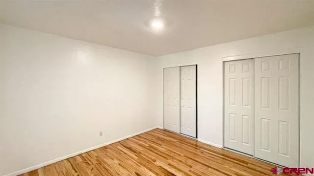 a view of a room with wooden floor