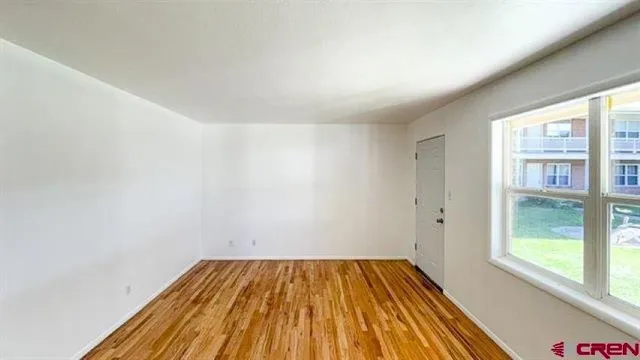 a view of a room with wooden floor and fence