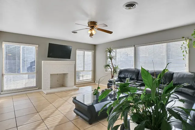 a living room with a fireplace and a flat screen tv