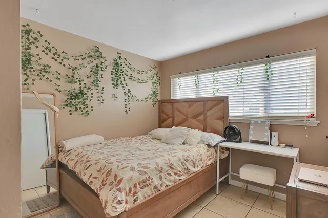 a bedroom with a bed and a window