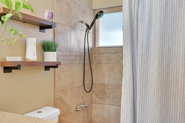 a bathroom with a bathtub and a shower