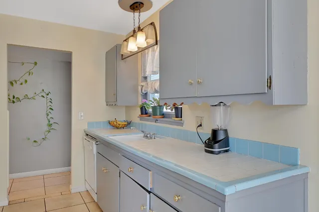 a kitchen with a refrigerator and cabinets