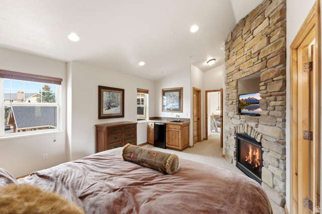 3634 North Huntsman Path, Unit C203 Eden, UT 84310 - Photo 9 of 27 Stone-clad fireplace with integrated media niche and built-in mini-bar with sink and cabinetry