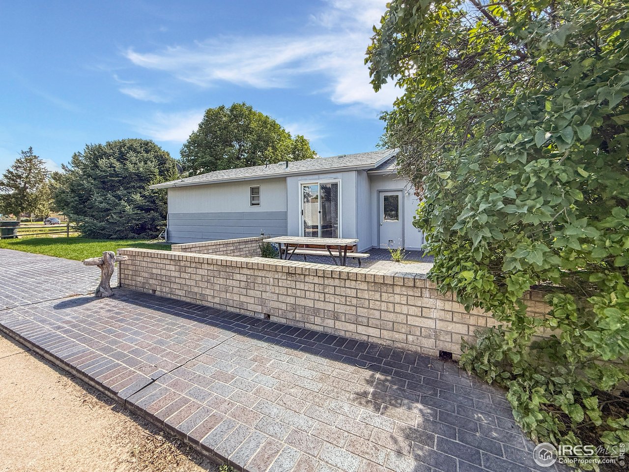 407 East Gordon Street Holyoke, CO 80734 - Photo 13 of 15 a view of house with backyard and trees