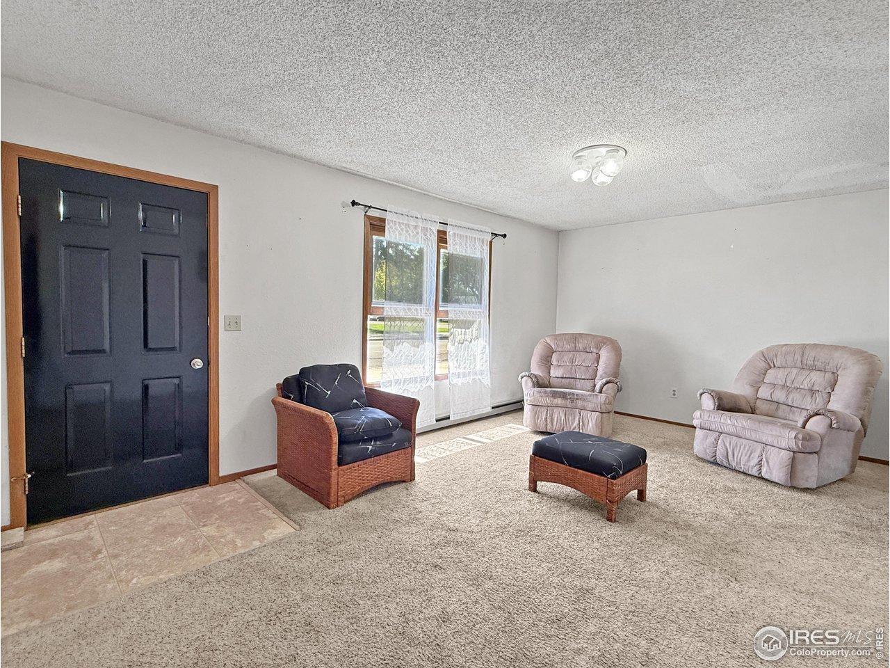 407 East Gordon Street Holyoke, CO 80734 - Photo 3 of 15 a living room with furniture and a window