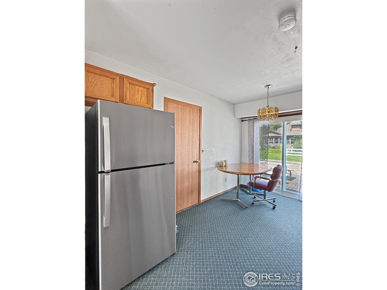 407 East Gordon Street Holyoke, CO 80734 - Photo 6 of 15 a kitchen with a refrigerator and furniture