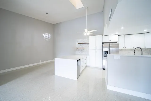 a view of kitchen with refrigerator and window