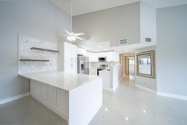 a kitchen with a sink stainless steel appliances and cabinets