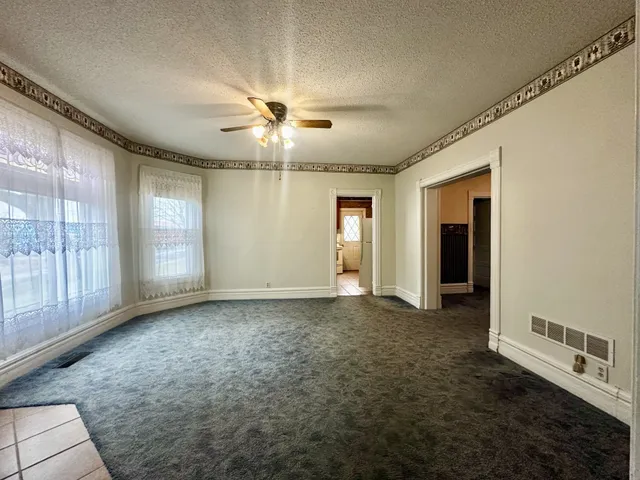 a view of a livingroom with a ceiling fan and window