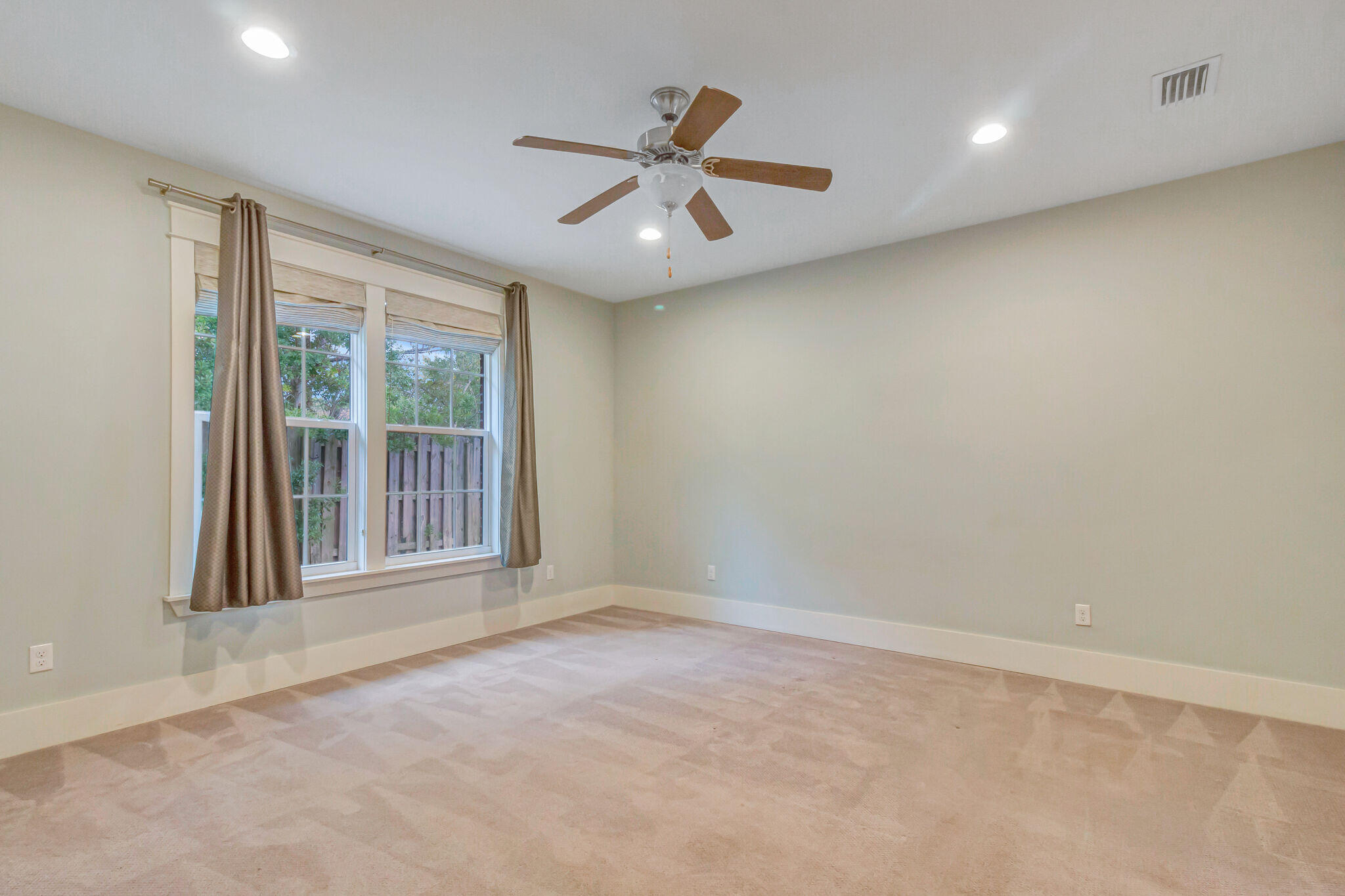 4232 Jade Loop Destin, FL 32541 - Photo 13 of 34 an empty room with ceiling fan and windows