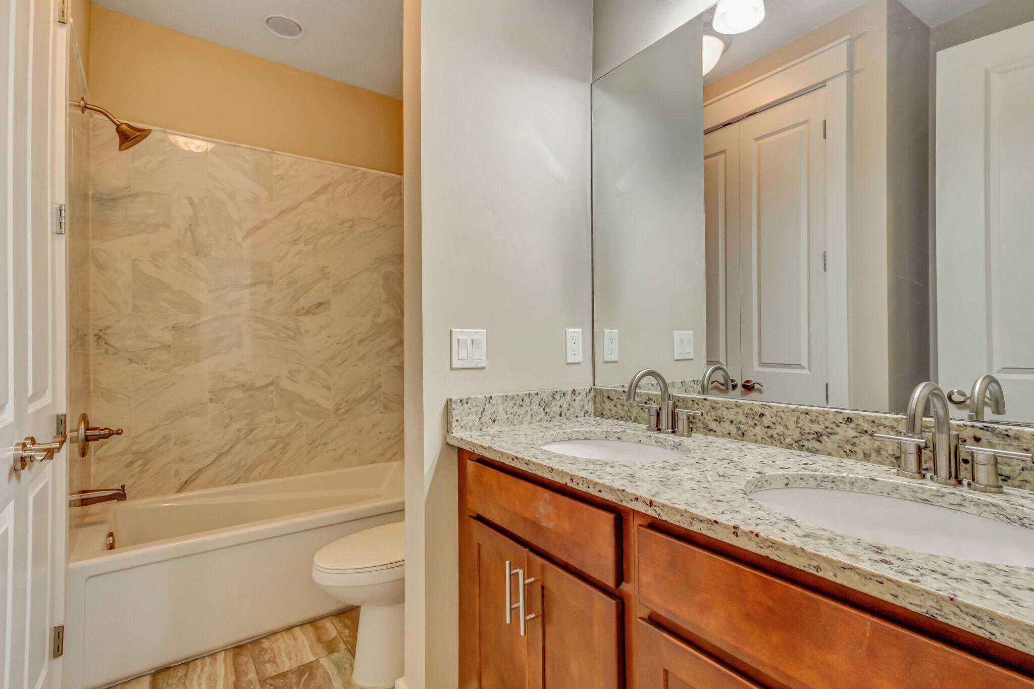 4232 Jade Loop Destin, FL 32541 - Photo 28 of 34 a bathroom with a granite countertop sink and a mirror a bathtub