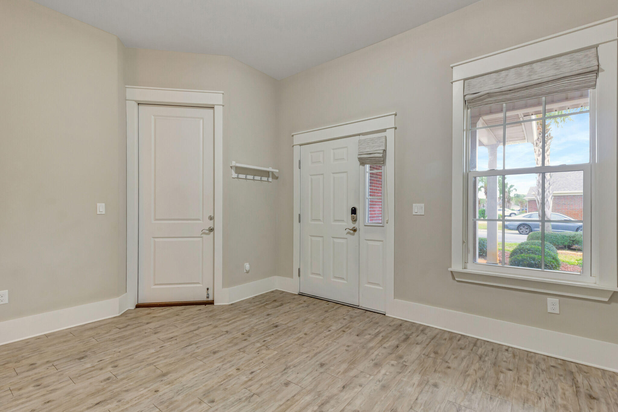 4232 Jade Loop Destin, FL 32541 - Photo 3 of 34 a view of an empty room with wooden floor and a window