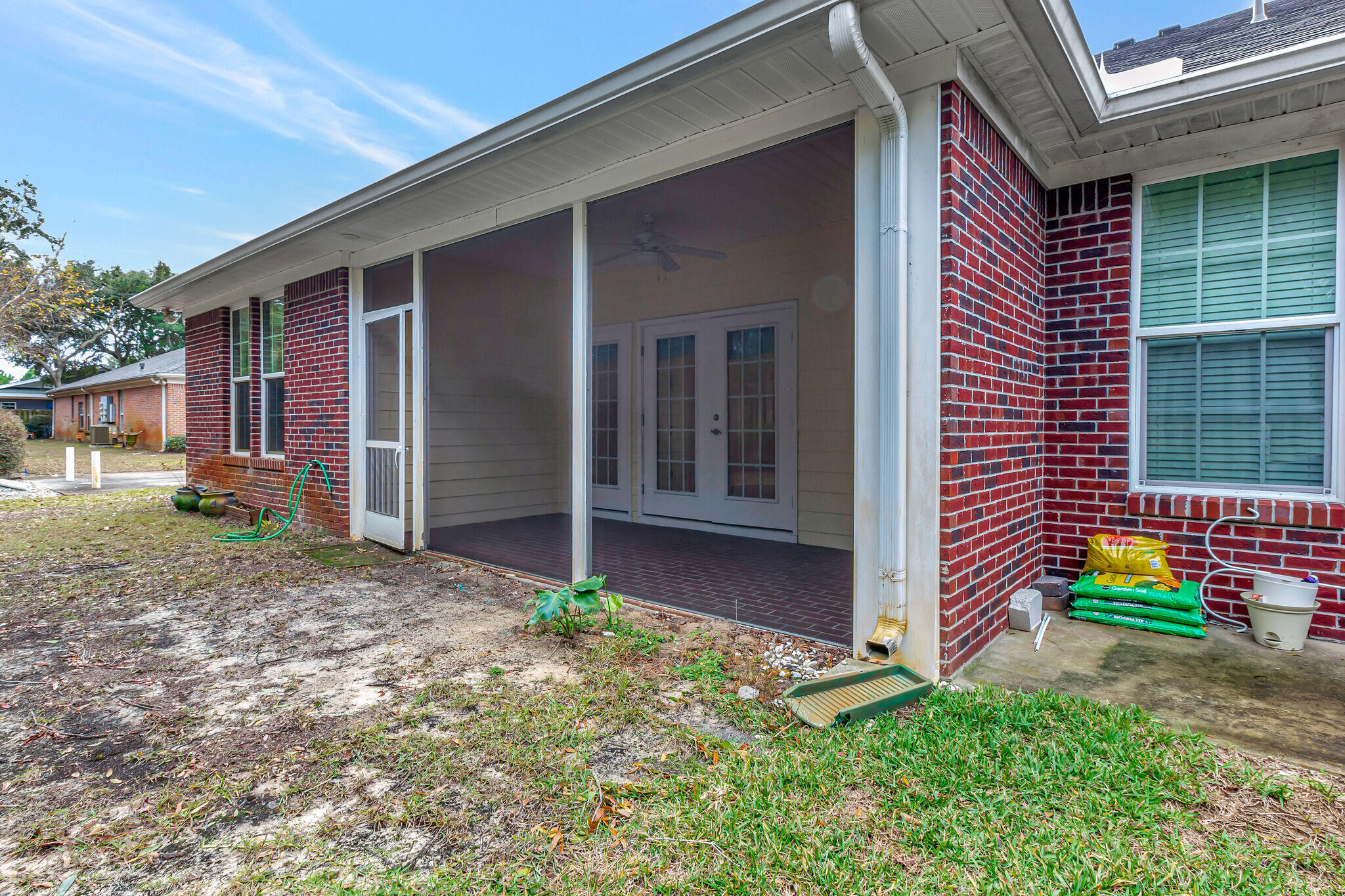 4232 Jade Loop Destin, FL 32541 - Photo 32 of 34 a backyard of a house with potted plants and a table