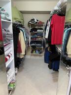 14096 Huntington Pointe Drive, Unit 106 Delray Beach, FL 33484 - Photo 10 of 47 a view of walk in closet with clothes and shoes