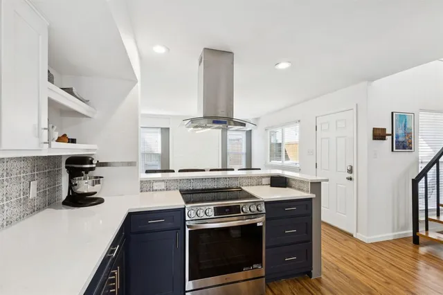 a kitchen with stainless steel appliances granite countertop a stove and a sink