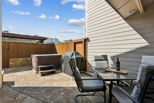 a balcony with table and chairs