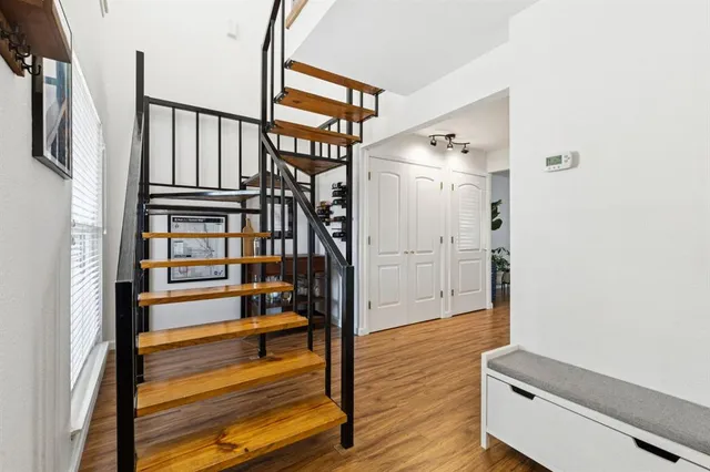 a view of entryway with wooden floor and stairs
