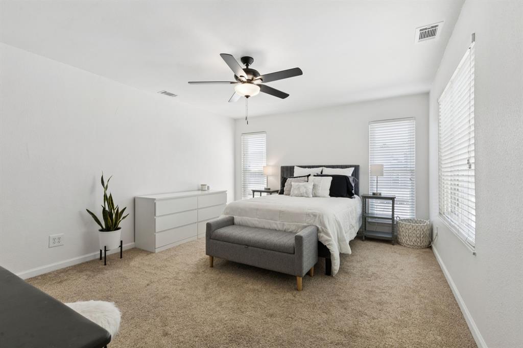 1641 Choteau Circle Grapevine, TX 76051 - Photo 16 of 29 a bedroom with a bed and a chandelier