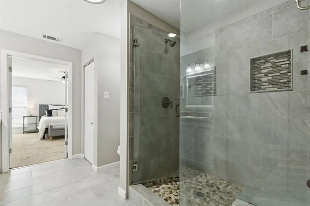 a bathroom with a glass door shower