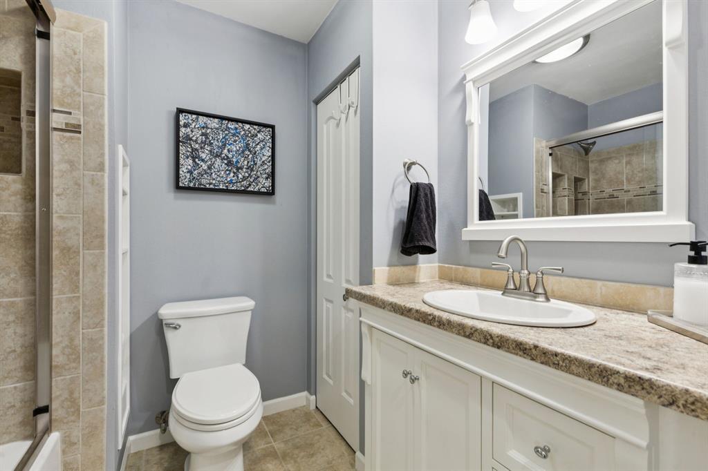 1641 Choteau Circle Grapevine, TX 76051 - Photo 22 of 29 a bathroom with a granite countertop toilet sink and mirror