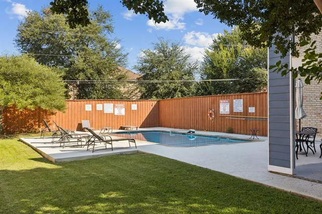 a view of a swimming pool with a yard
