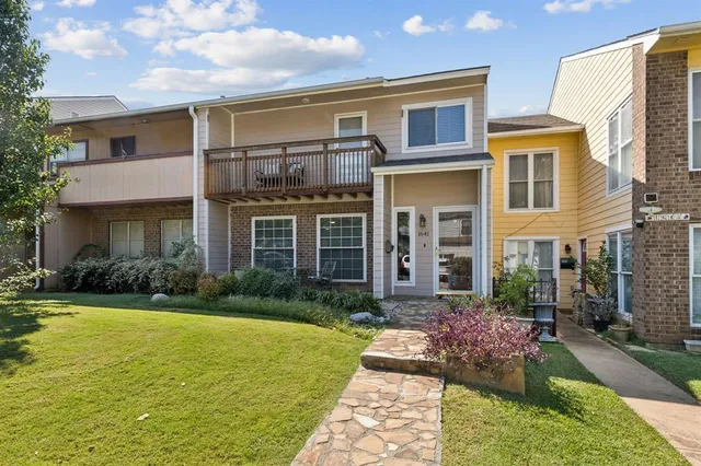a front view of a house with yard and green space
