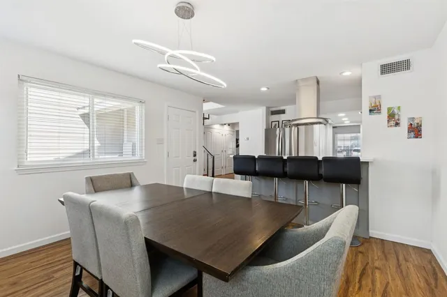 a dining room with furniture and wooden floor
