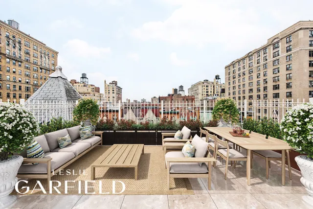 a view of a patio with couches and a table and chairs