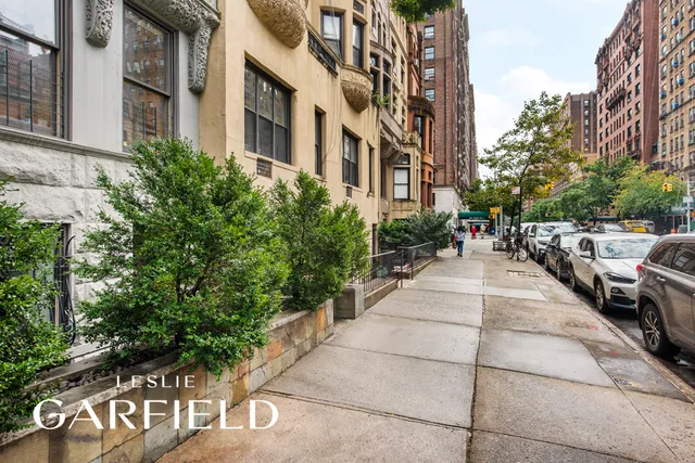 a pathway of a building with a yard