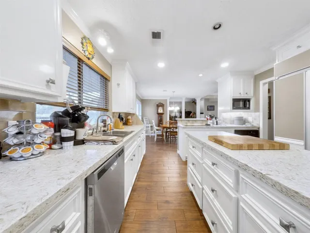 a large kitchen with stainless steel appliances lots of counter top space