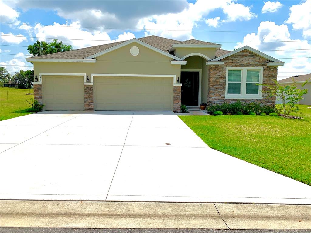 4552 Southwest 65th Place Ocala, FL 34474 - Photo 1 of 1 a front view of a house with a garden
