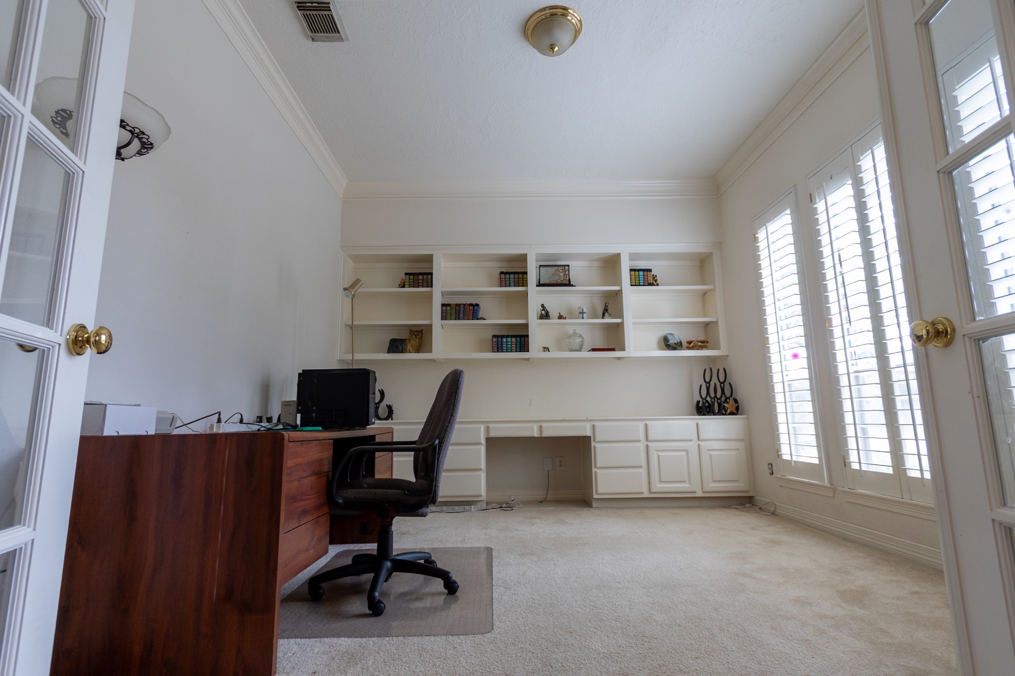 5718 Oakmoss Trail Spring, TX 77379 - Photo 22 of 50 Bright, inviting, and private study or sitting room off the entry, featuring custom shutters.