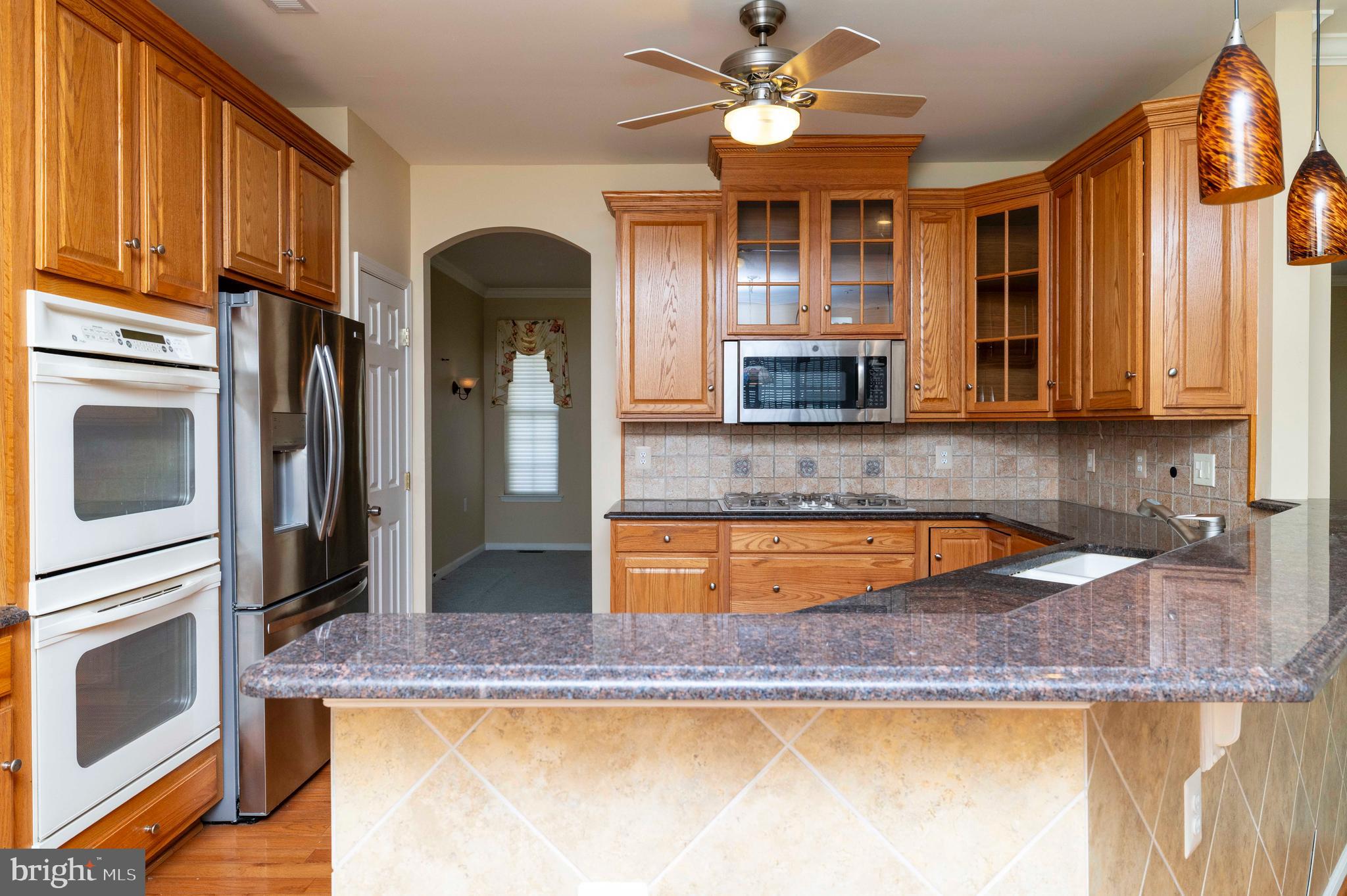1028 Conway Court Warminster, PA 18974 - Photo 14 of 32 a kitchen with granite countertop stainless steel appliances a stove refrigerator and cabinets