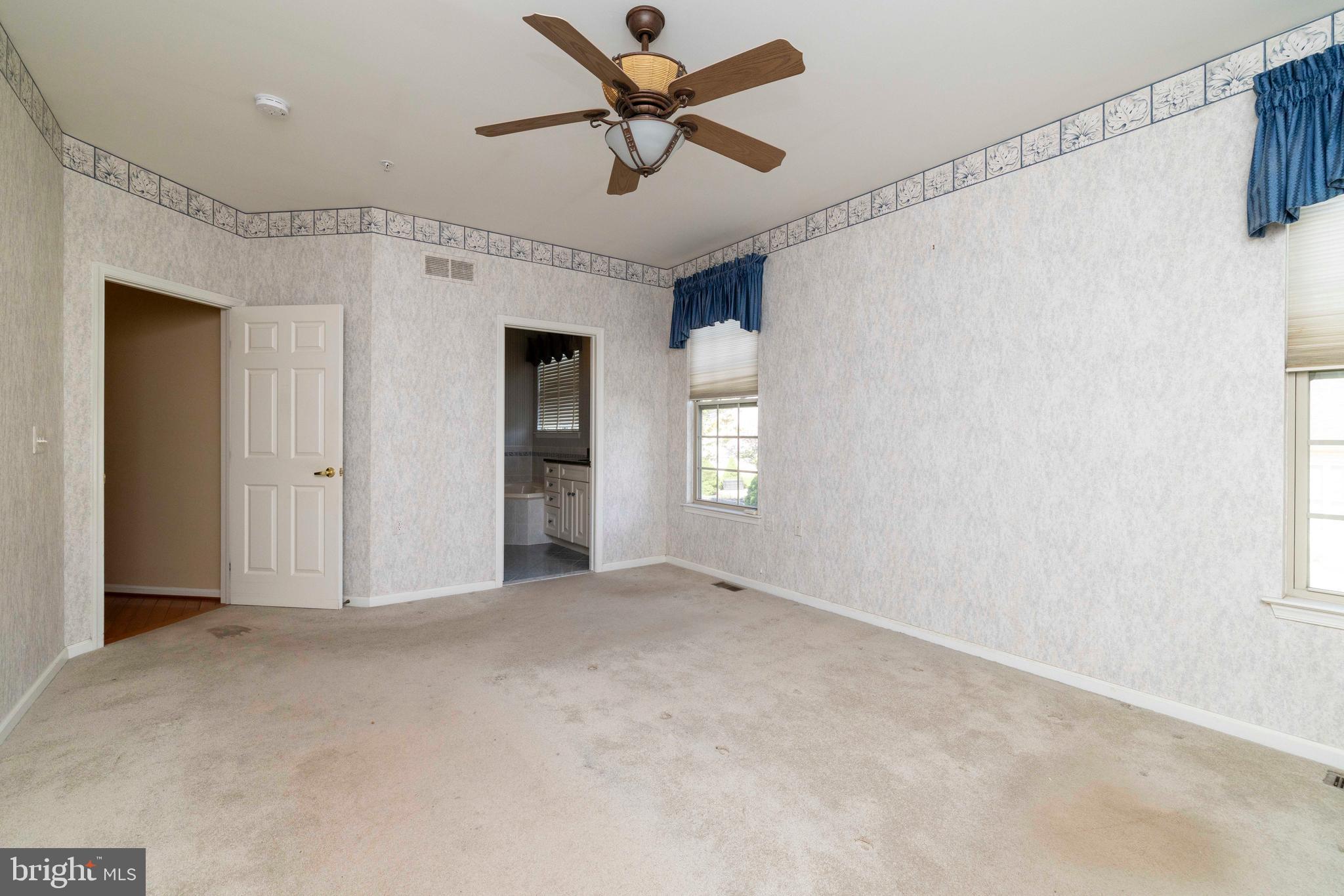 1028 Conway Court Warminster, PA 18974 - Photo 21 of 32 a view of a livingroom with a ceiling fan & windows