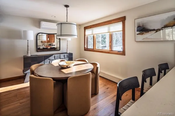 a dining room with furniture and window