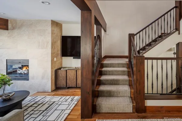 a view of a hallway with wooden floor and entryway