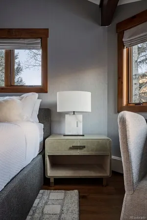 a bedroom with a bed a mirror and a window