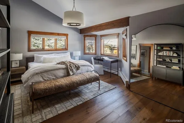 a bedroom with a large bed and a couch