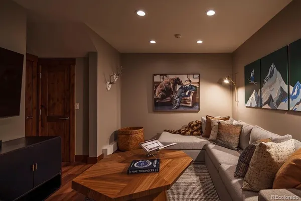 a living room with furniture and a painting on the wall