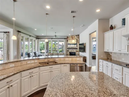 a large white kitchen with lots of counter space and appliances