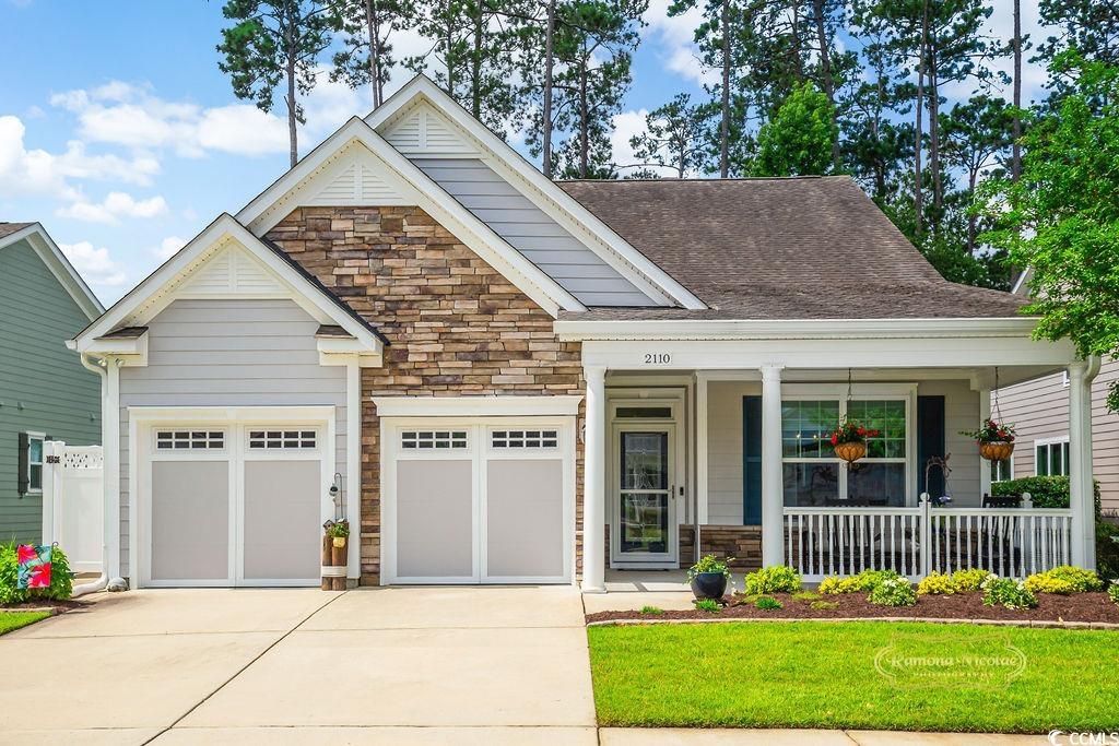 2110 Silver Spring Lane Myrtle Beach, SC 29577 - Photo 1 of 40 Craftsman house with stone siding, driveway, a porch, a garage, and roof with shingles
