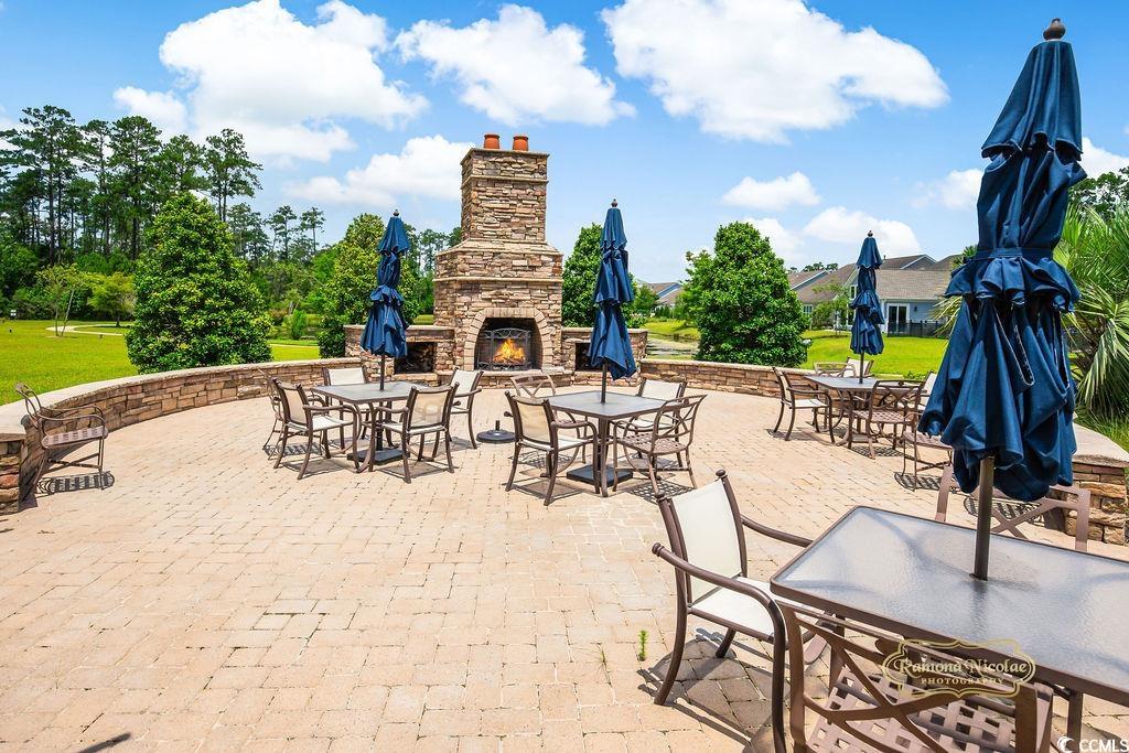 2110 Silver Spring Lane Myrtle Beach, SC 29577 - Photo 36 of 40 View of patio with an outdoor stone fireplace and outdoor dining area