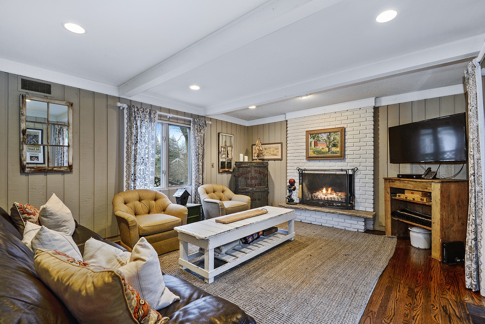 1034 Pontiac Road Wilmette, IL 60091 - Photo 11 of 32 a living room with furniture flat screen tv and a fireplace
