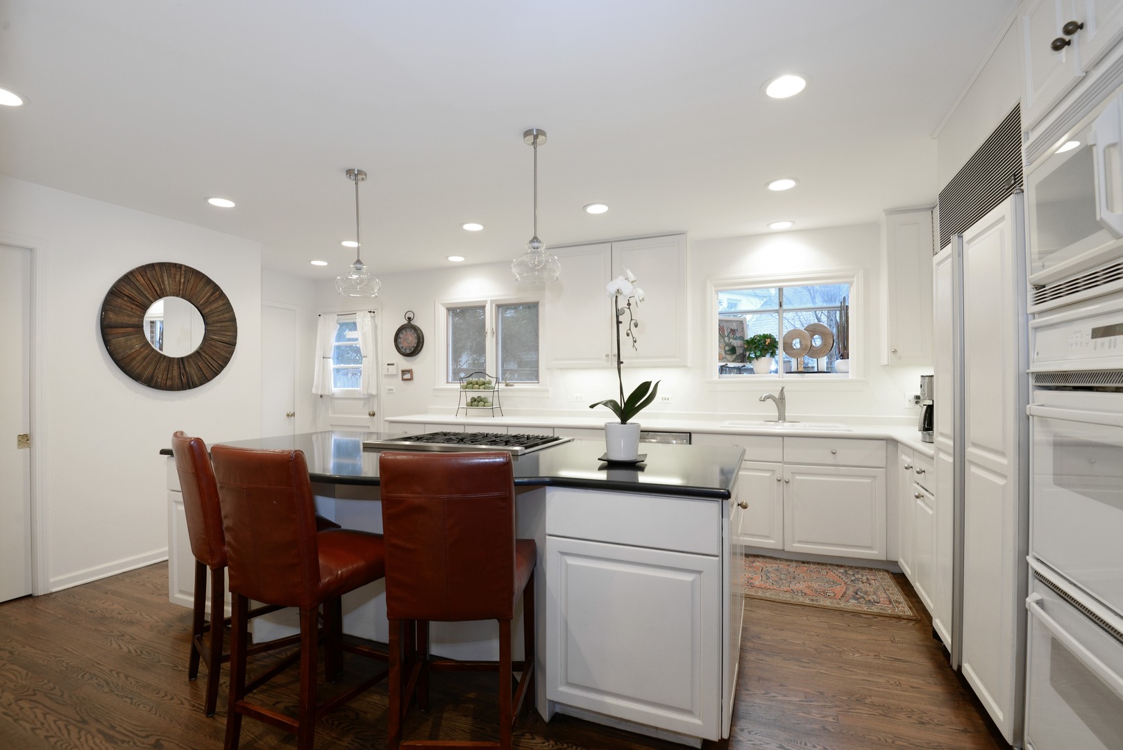 1034 Pontiac Road Wilmette, IL 60091 - Photo 8 of 32 a kitchen with a dining table chairs and cabinets