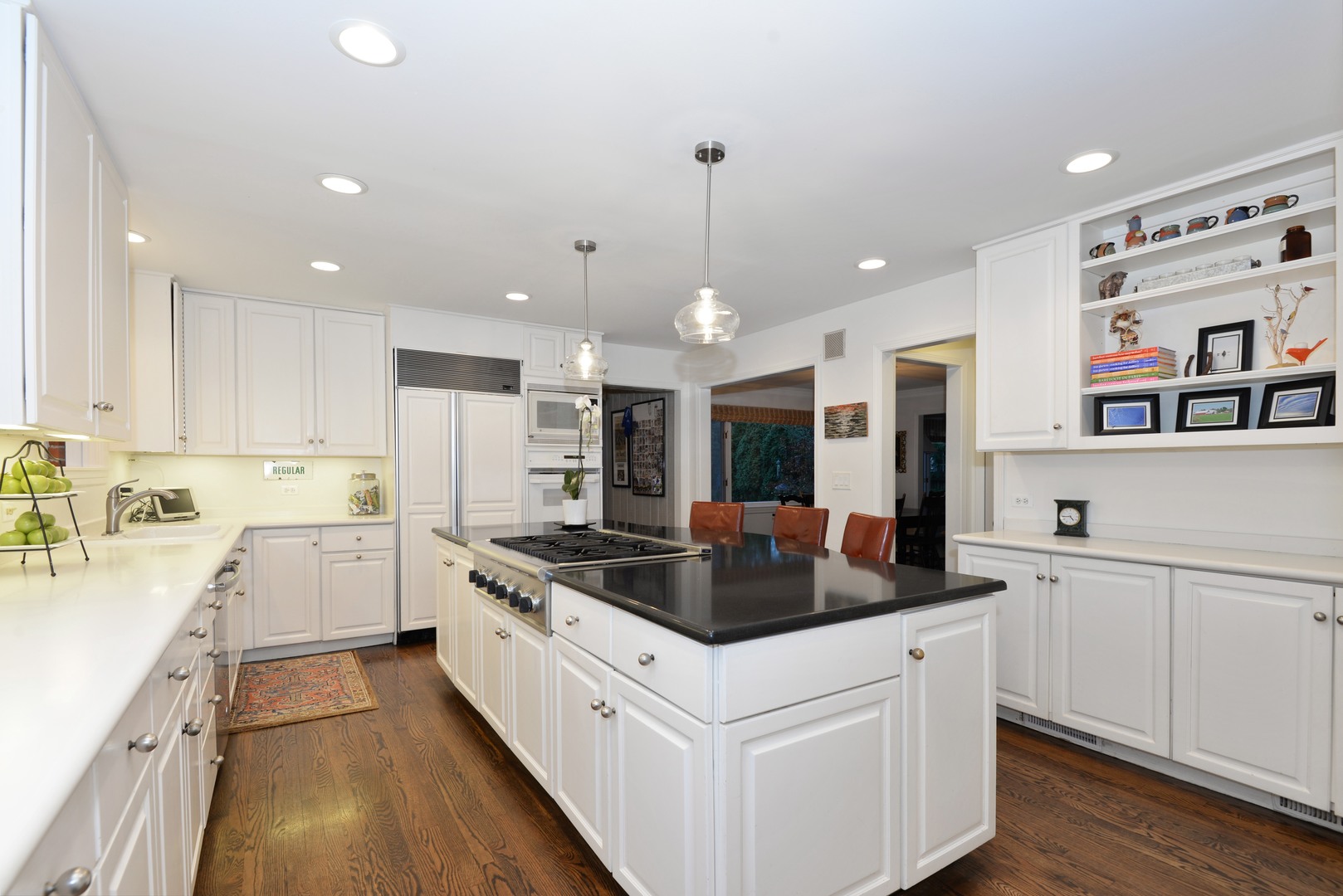 1034 Pontiac Road Wilmette, IL 60091 - Photo 9 of 32 a kitchen that has a lot of cabinets and wooden floor