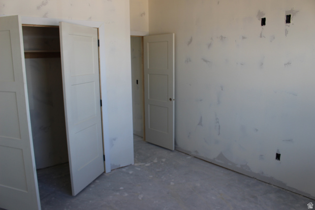 4933 East Remington Road Cedar City, UT 84721 - Photo 14 of 33 Unfinished interior space featuring light-colored walls, built-in shelving, and panel doors