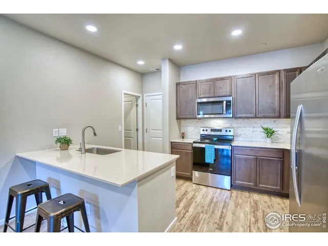a kitchen with a sink appliances and cabinets